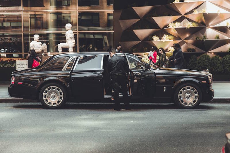 Mississauga Chauffeur Service Professional chauffeur with a black luxury sedan in Mississauga
